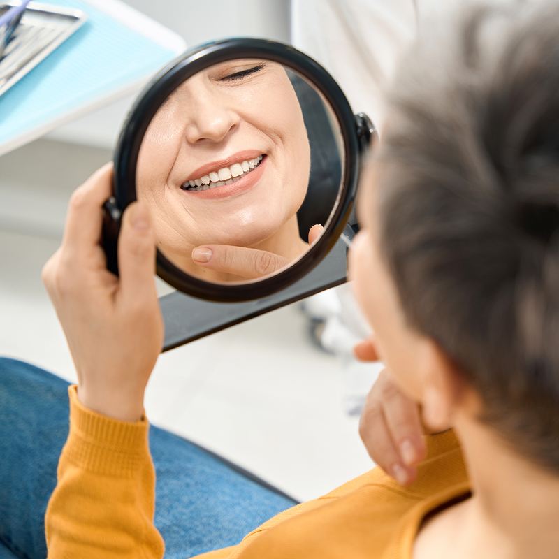 senior man being shown dentures